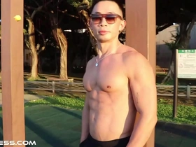 Muscular Asian man shows off his physique during outdoor workout
